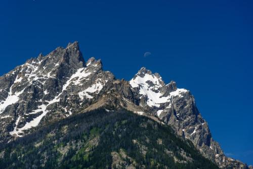The moon over snowy peaks, Grand Teton National Park.  ©2018 Kevin Novak.