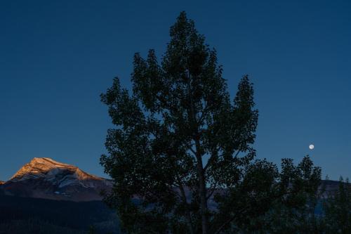 Setting moon and rising sun, Glacier National Park, Montana.